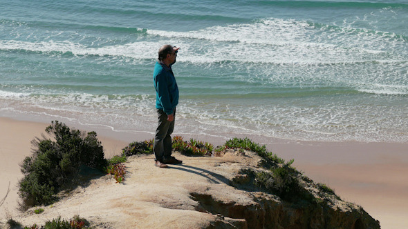 Man Climb on a Cliff Above the Ocean Man Climb on a Cliff Above the Ocean