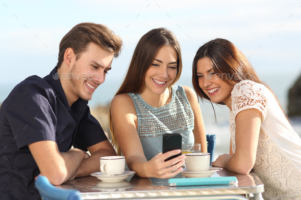 Group of friends watching social media in a smart phone