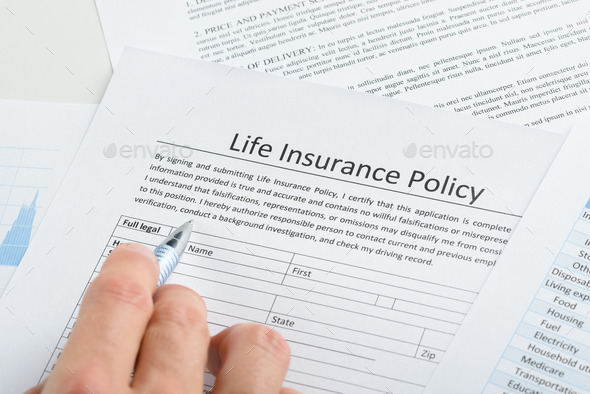 Person Filling Application For Life Insurance