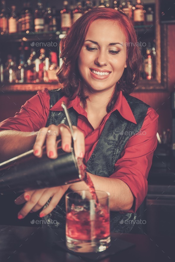 Beautiful redhead barmaid making cocktail (Misc) Photo Download