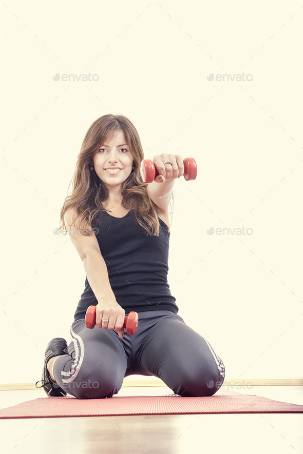 athletic girl with weights or red dumbbells wearing sports clot (Misc) Photo Download