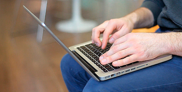 Man Sitting and Working on a Laptop Man Sitting and Working on a Laptop