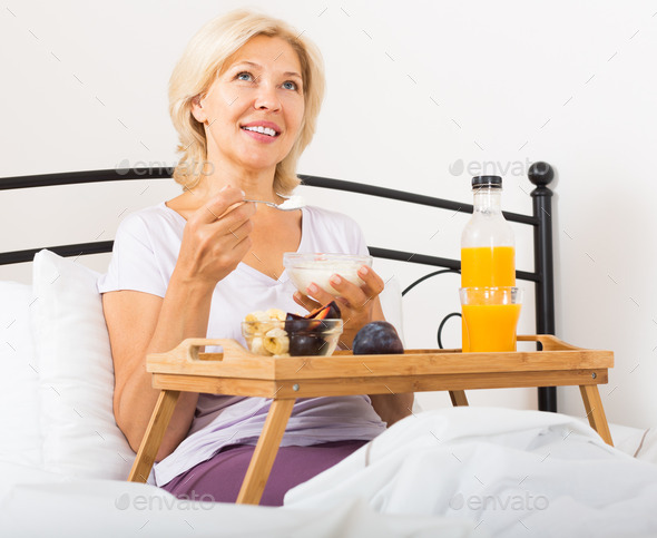 mature woman enjoying healthy breakfast (Misc) Photo Download