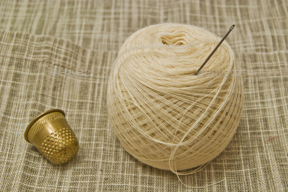 yarn with needle and thimble