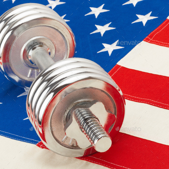 Silver color dumbbell over US flag as symbol of healthy life style (Misc) Photo Download