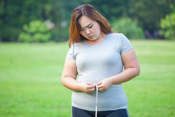 Fat woman measuring her stomach (Misc) Photo Download