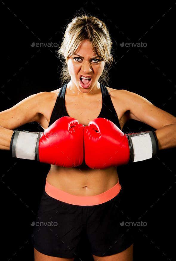 aggressive sexy boxing fighter girl with red gloves in angry face expression sport fitness concept