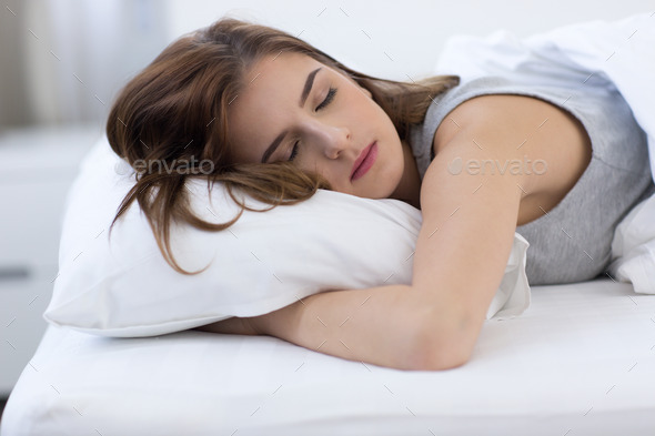 Portrait of a woman sleeping on the bed at home