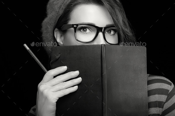 Pretty College Girl Covering her Face with Black Notebook