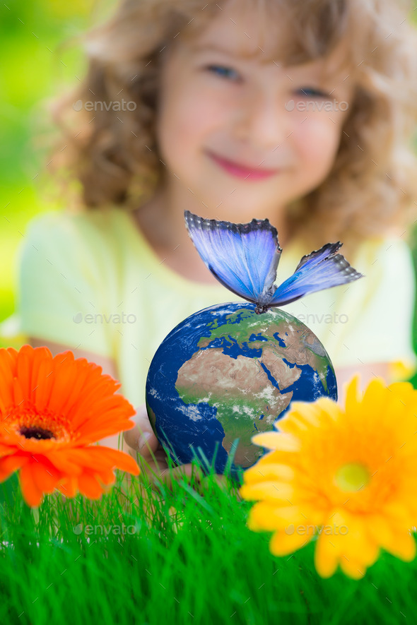 Child holding Earth planet with blue butterfly in hands (Misc) Photo Download