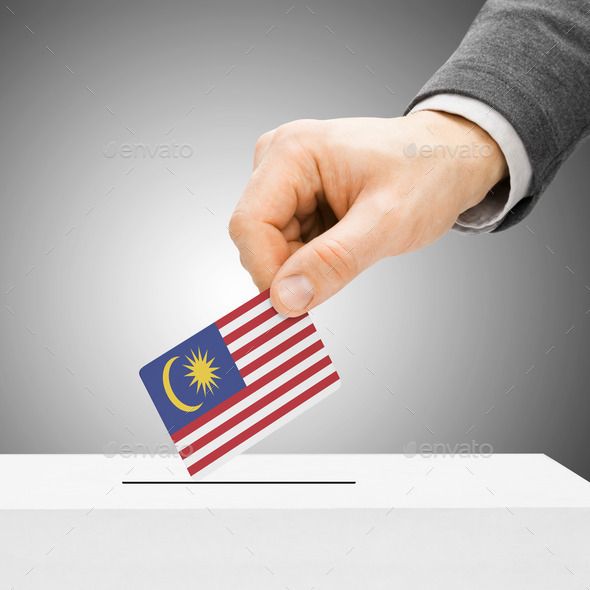 Voting concept - Male inserting flag into ballot box - Malaysia (Misc) Photo Download