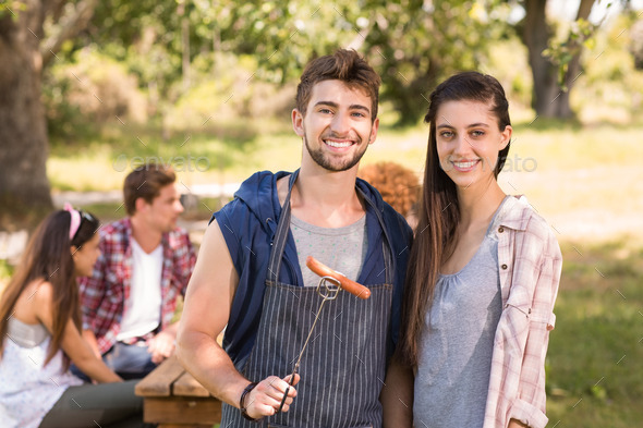 Happy friends in the park having barbecue on a sunny day (Misc) Photo Download