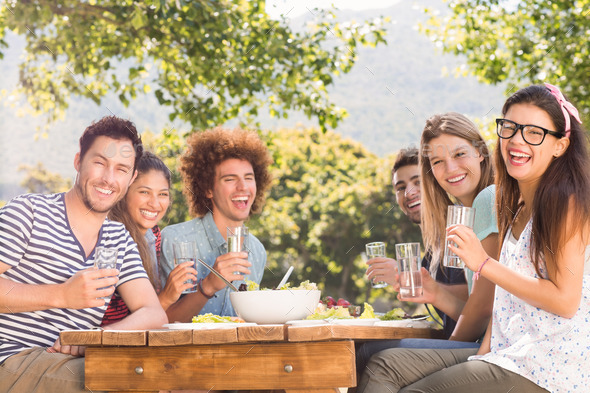 Happy friends in the park having lunch on a sunny day (Misc) Photo Download