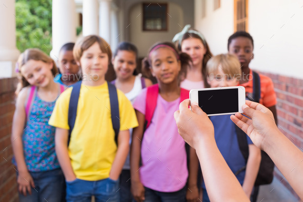 Cute pupils using mobile phone at the elementary school (Misc) Photo Download