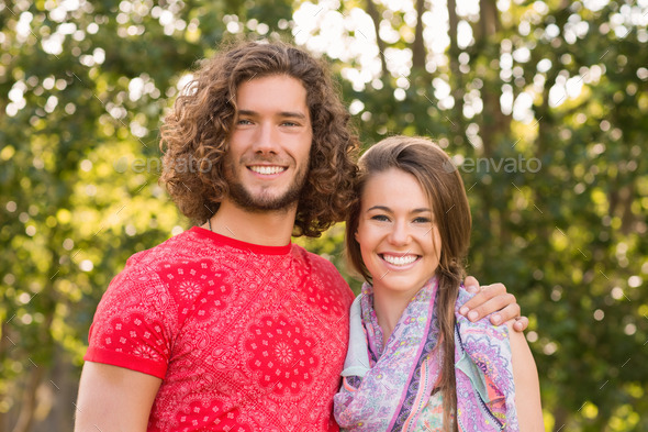 Friends smiling at camera in the park on a sunny day (Misc) Photo Download