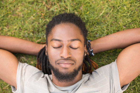 Handsome hipster relaxing in the park on a sunny day (Misc) Photo Download