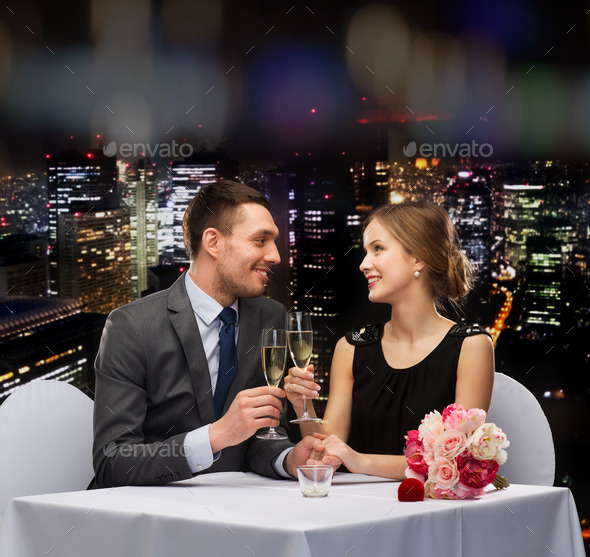 couple with glasses of champagne at restaurant (Misc) Photo Download