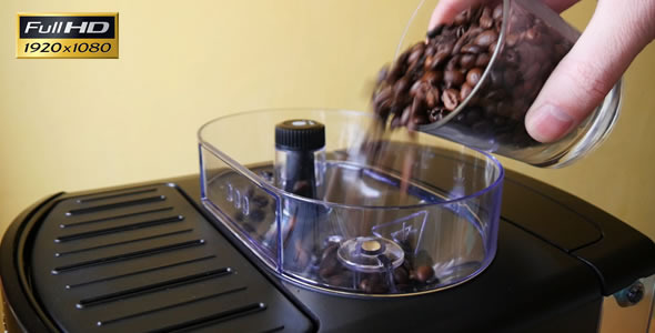 Adding of Roasted Coffee Beans to the Coffee Machi Adding of Roasted Coffee Beans to the Coffee Machi