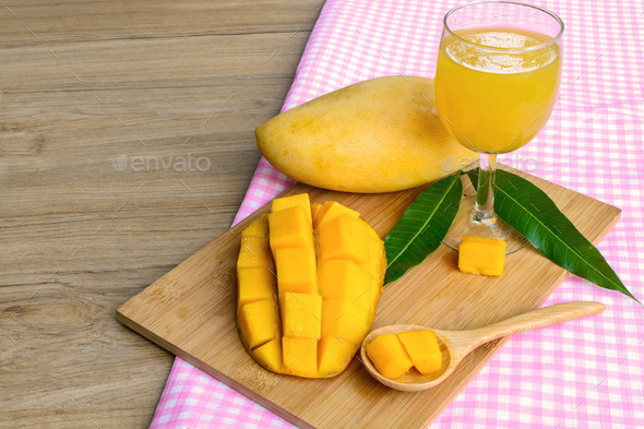 Yellow mango on wooden table (Misc) Photo Download