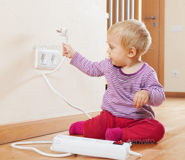 Toddler playing with electrical extension