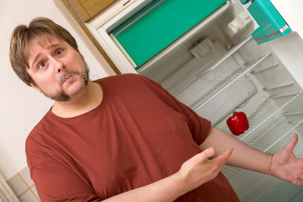 young thick man in front of a frigde with one paprika inside (Misc) Photo Download