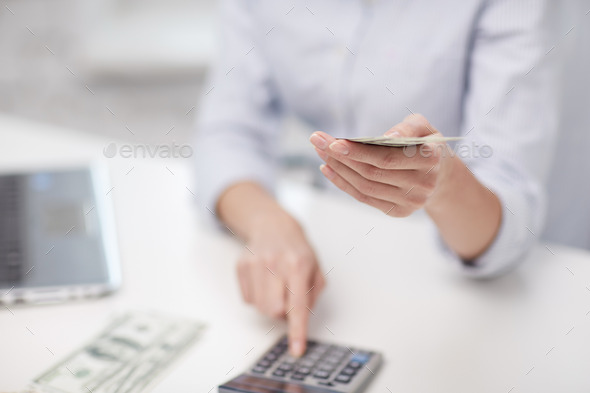 close up of woman counting money with calculator (Misc) Photo Download