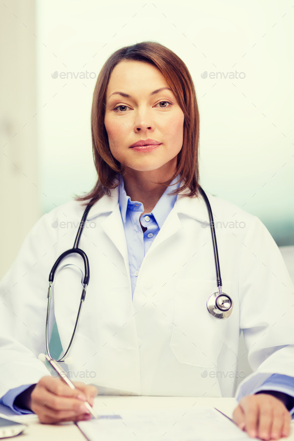 busy doctor with laptop computer and clipboard (Misc) Photo Download