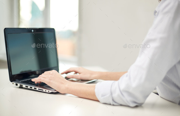 close up of woman typing on laptop at office (Misc) Photo Download