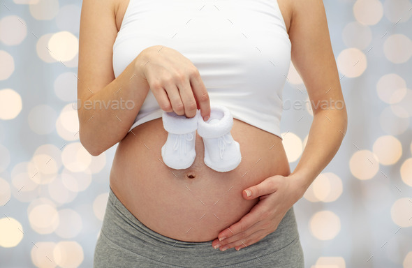 close up of pregnant woman with babys bootees (Misc) Photo Download