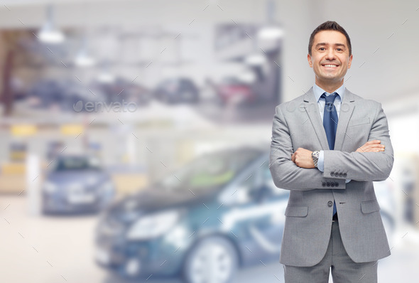 happy man at auto show or car salon (Misc) Photo Download