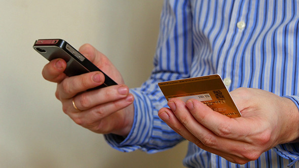Businessman Paying With Credit Card On Phone Businessman Paying With Credit Card On Phone
