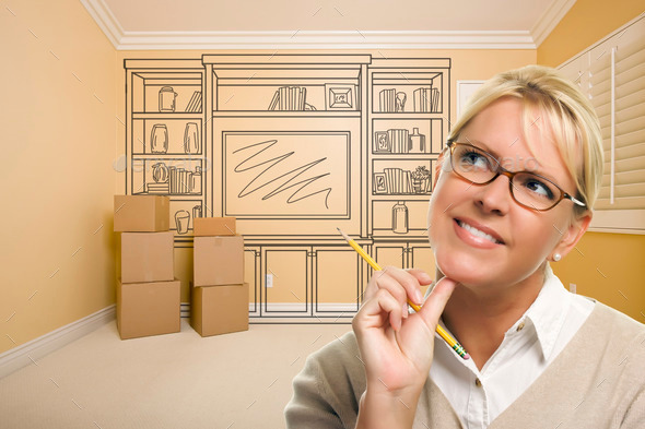 Daydreaming Woman Holding Pencil In Empty Rom with Built In Shelf Design Drawing on Wall. (Misc) Photo Download