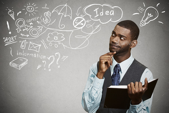 man with book thinking dreaming has many ideas looking up (Misc) Photo Download