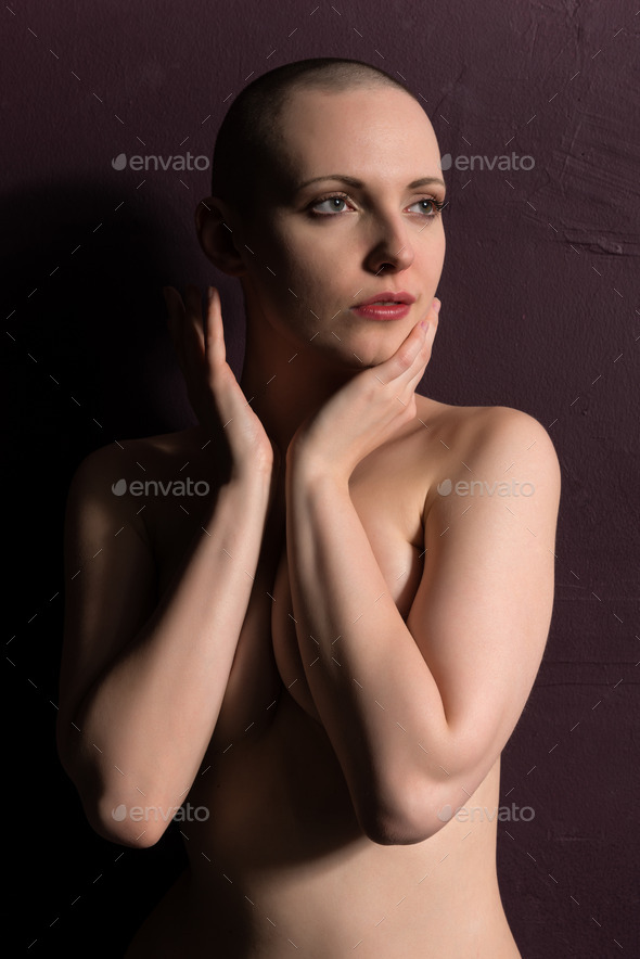 Portrait of a beautiful woman covering her breasts stock photo - OFFSET