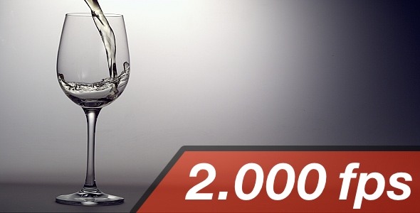 White Wine Is Pouring Into A Wine Glass White Wine Is Pouring Into A Wine Glass