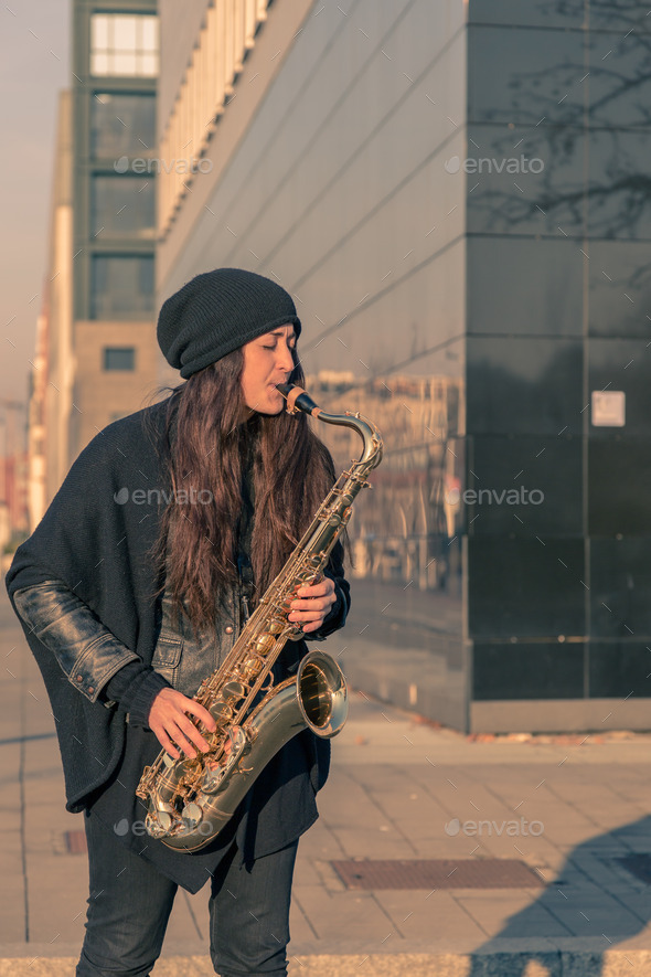 Beautiful young woman playing tenor saxophone (Misc) Photo Download