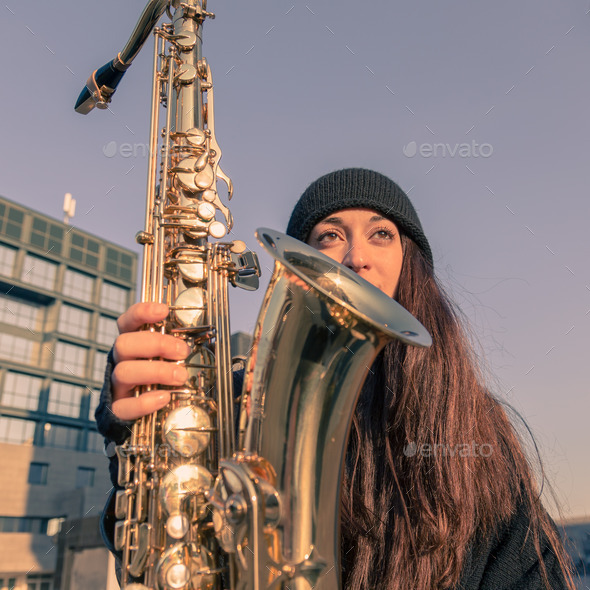 Beautiful young woman with her saxophone (Misc) Photo Download