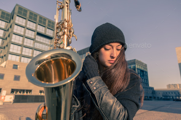 Beautiful young woman with her saxophone (Misc) Photo Download