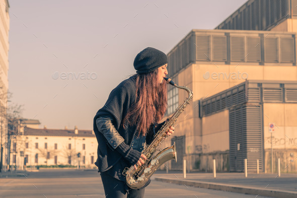 Beautiful young woman playing tenor saxophone (Misc) Photo Download