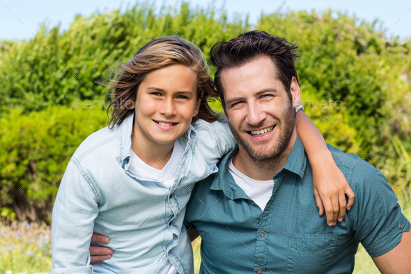 Father and son smiling at camera in the countryside (Misc) Photo Download