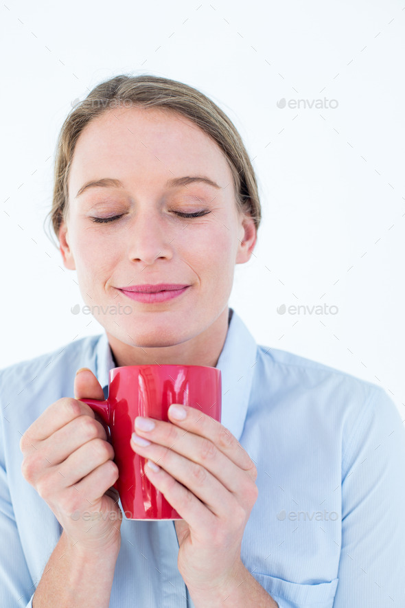 Businesswoman smelling her coffee on white background (Misc) Photo Download