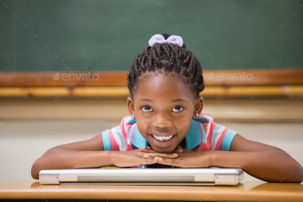 Smiling pupil sitting at her desk at the elementary school (Misc) Photo Download