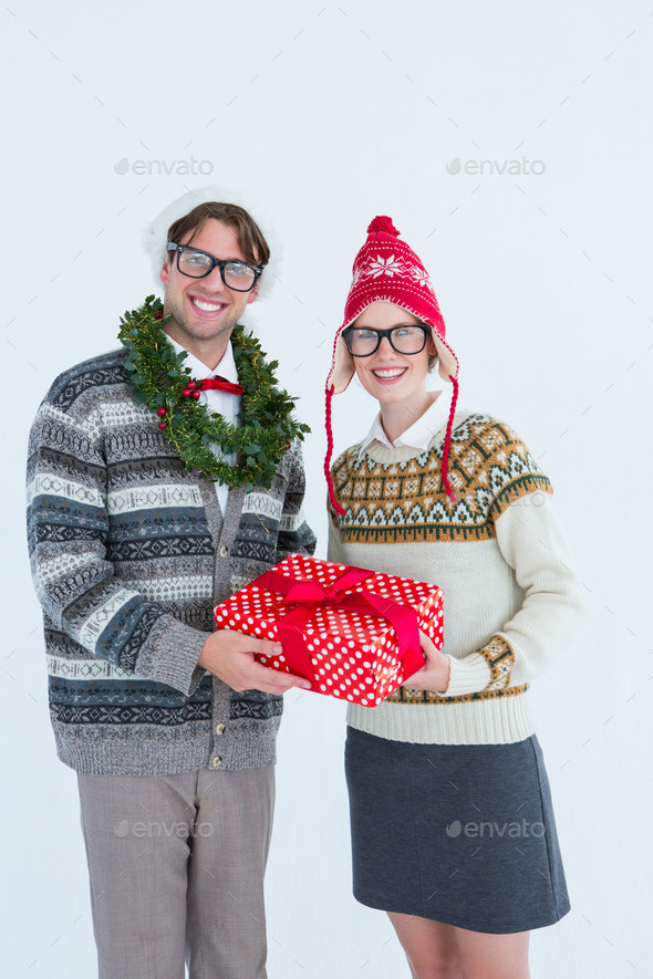 Geeky hipster couple holding present on white background (Misc) Photo Download