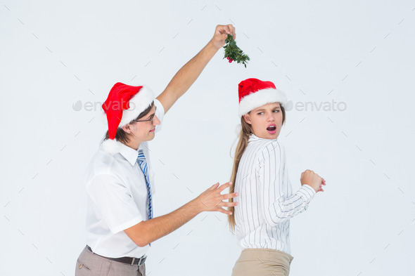 Geeky hipster running away from a man with mistletoe on white background (Misc) Photo Download