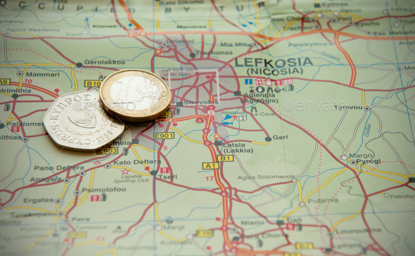 Euro coin and old cyprus coins on a map