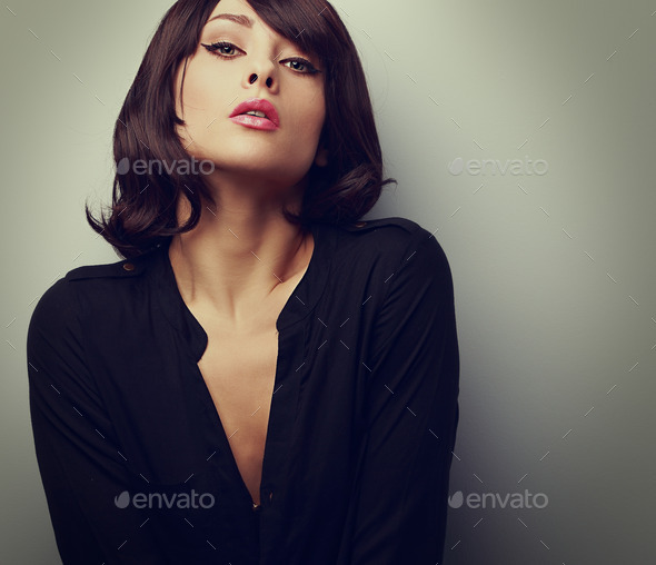 Hot sexy woman with short hair posing in black shirt. Vintage