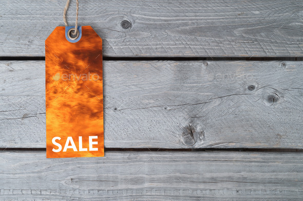 Fire sale concept with a sale tag on wooden table