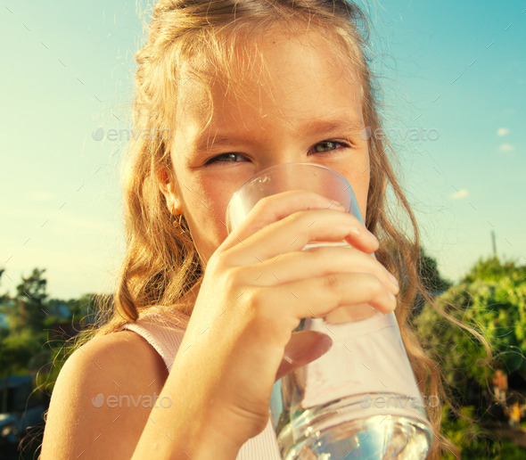 Girl holding glass with water