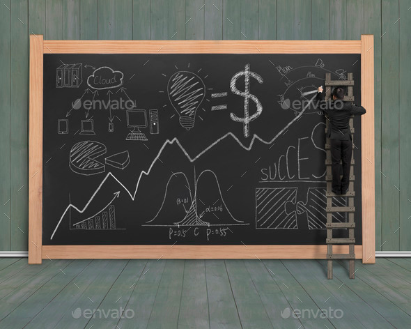 Businessman drawing business concept doodles on black chalkboard (Misc) Photo Download