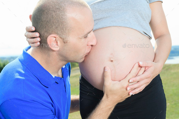 A portrait of a pregnant wife with her husband.
